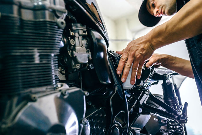 mechanic repairing motorcycle